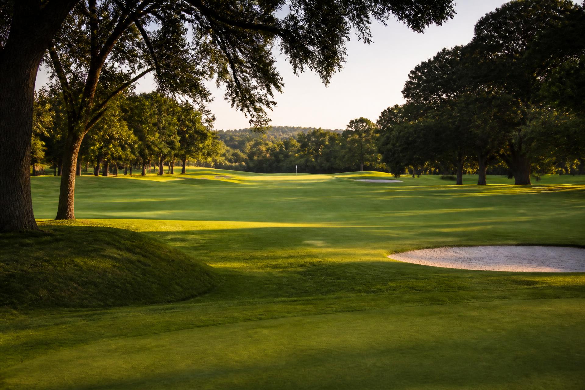 Sunrise over a rolling public golf course fairway